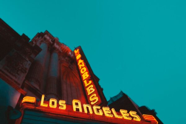 low angle photography of brown building with los angeles led sign